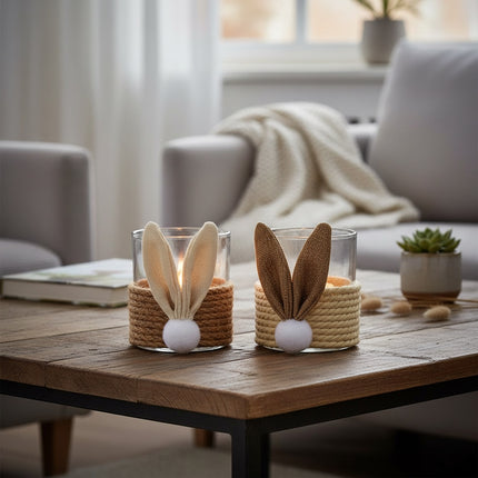 DekoSturm glass hurricane candle holders with jute rope wrap and bunny ears, one in natural jute, one in brown jute.